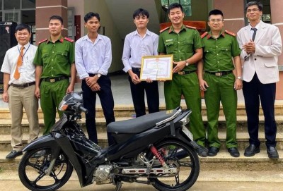 Đại diện Công an Thị trấn Hai Riêng và Trường Trung học phổ thông Nguyễn Du trao giấy khen cho em Kpắ Y Sem và trả lại xe máy bị trộm cho em Kso Y Thai.