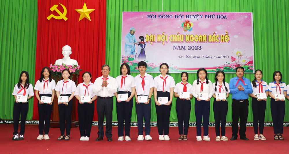 Lãnh đạo huyện Phú Hòa trao giấy chứng nhận Cháu ngoan Bác Hồ cho các đội viên ưu tú.