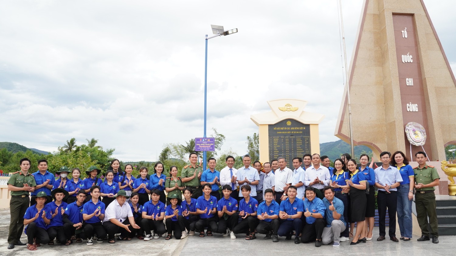 Các đại biểu và chiến sĩ tình nguyện khánh thành công trình "Ánh sáng tri ân" tại khu vực Nghĩa trang liệt sĩ xã Đa Lộc.