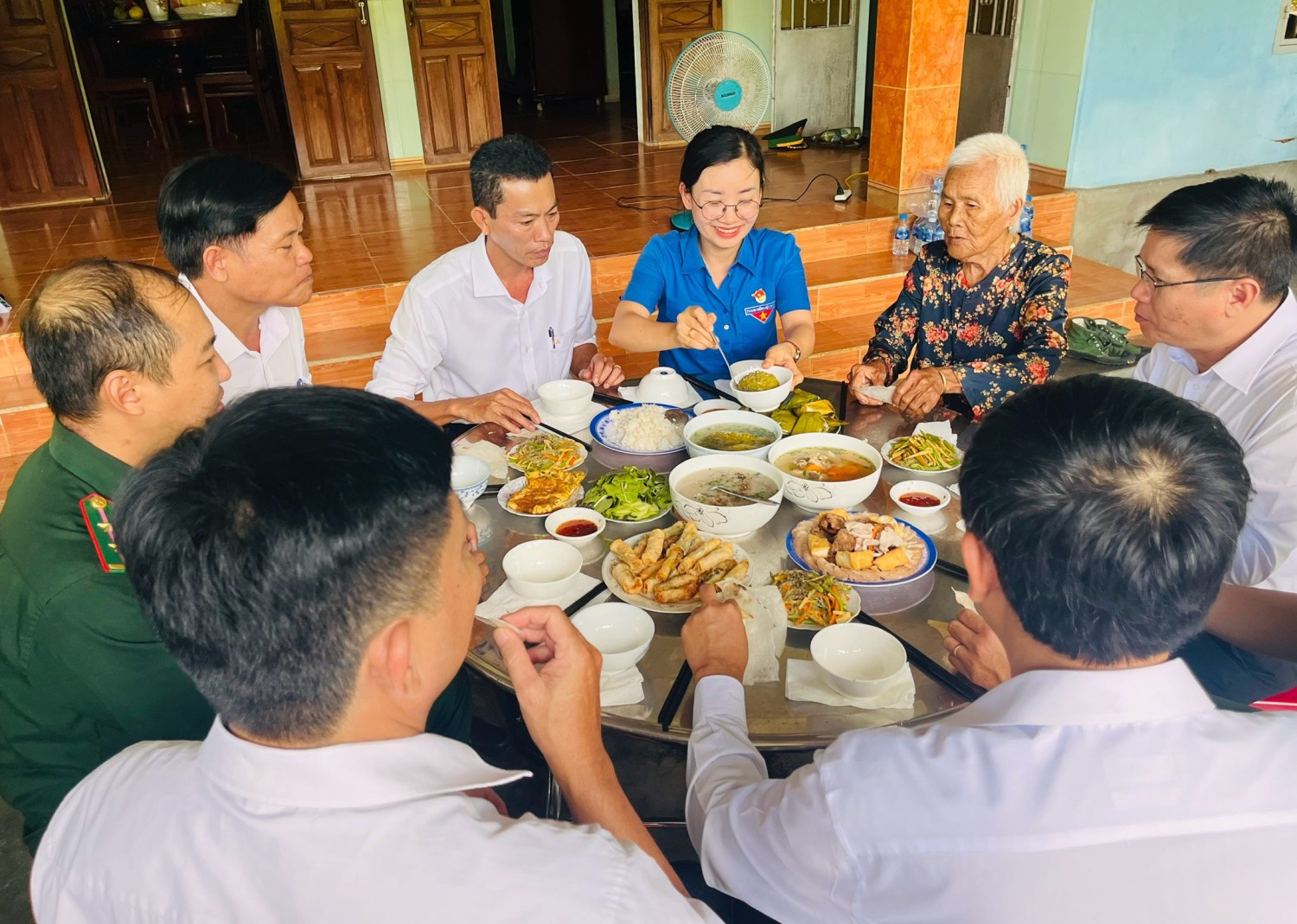 Chú thích ảnh: Lãnh đạo huyện và đoàn viên, thanh niên quây quần ăn cơm cùng Mẹ Việt Nam anh hùng Lê Thị Tha (xã An Hòa Hải).